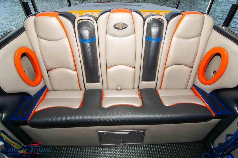 Slide: The Image of Luxurious seating in a 2007 Cigarette 42X boat with vibrant orange and blue accents. - 18