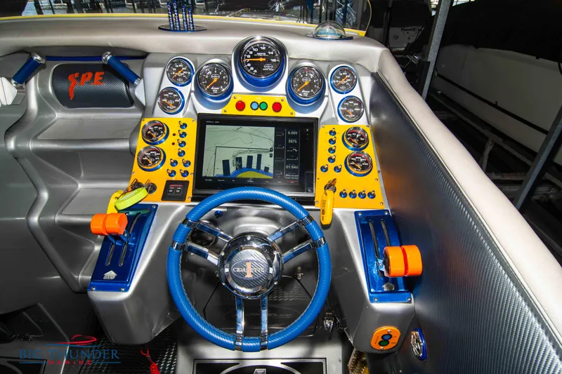 Slide: The Image of Dashboard of a 2007 Cigarette 42X boat with vibrant controls and steering wheel. - 24