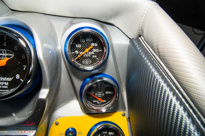 Slide: The Image of Dashboard gauges of a 2007 Cigarette 42X boat, featuring carbon fiber accents. - 28