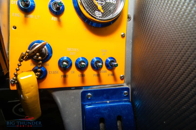 Slide: The Image of Close-up of 2007 Cigarette 42X control panel with switches and keychain. - 30