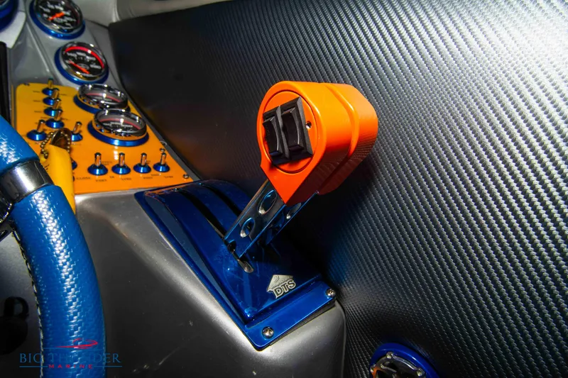 Slide: The Image of Dashboard of a 2007 Cigarette 42X boat with vibrant controls and carbon fiber finish. - 36