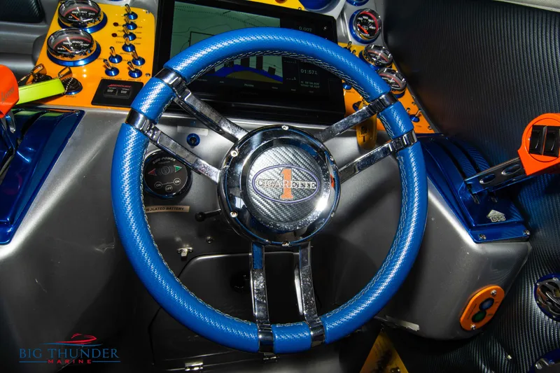 Slide: The Image of 2007 Cigarette 42X boat steering wheel with blue leather and chrome accents. - 38