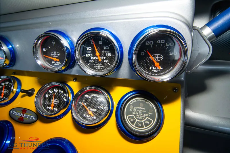 Slide: The Image of Dashboard gauges of a 2007 Cigarette 42X boat, featuring fuel and transmission indicators. - 49