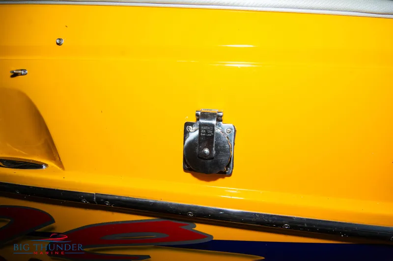 Slide: The Image of Close-up of a 2007 Cigarette 42X boat's yellow exterior with a metal fixture. - 6