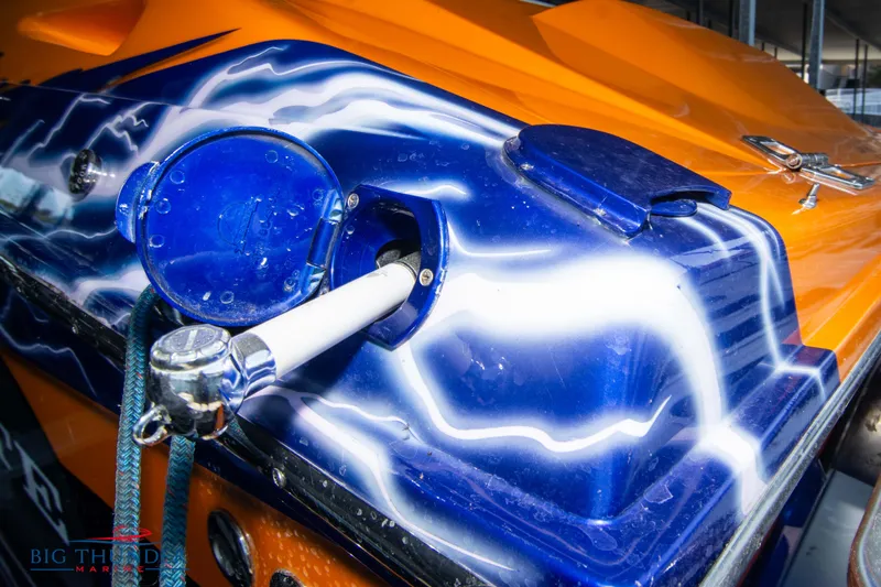 Slide: The Image of Close-up of a 2007 Cigarette 42X boat with vibrant blue and orange paint. - 7