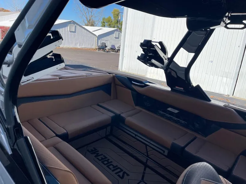 Slide: The Image of 2024 Supreme S240 boat interior with tan seating and sleek design. - 10
