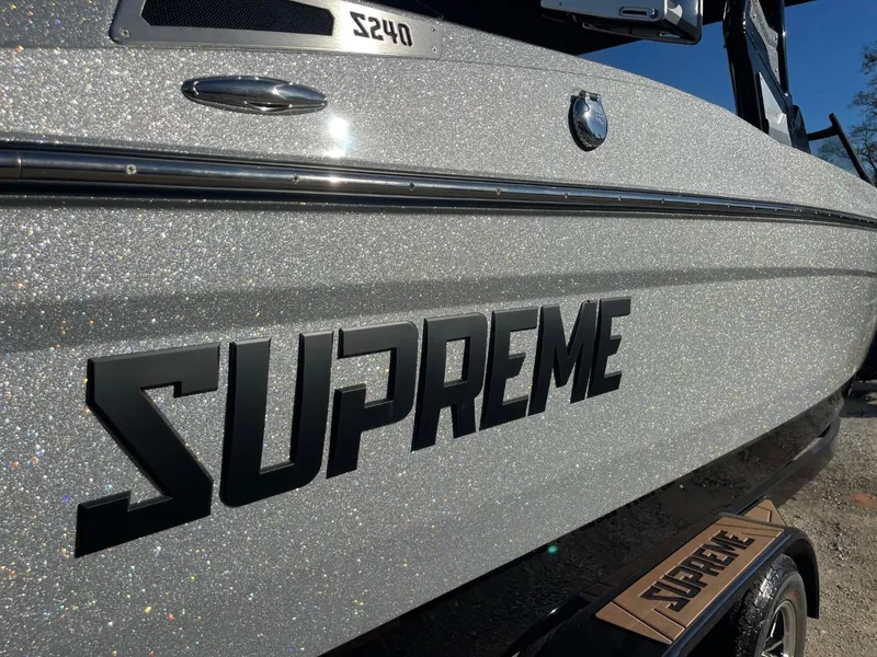 Slide: The Image of 2024 Supreme S240 boat with glittering silver finish and bold logo. - 15