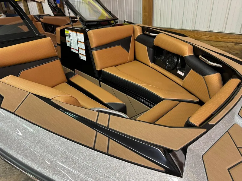 Slide: The Image of 2024 Supreme S240 boat interior with tan and black seating, modern design. - 18
