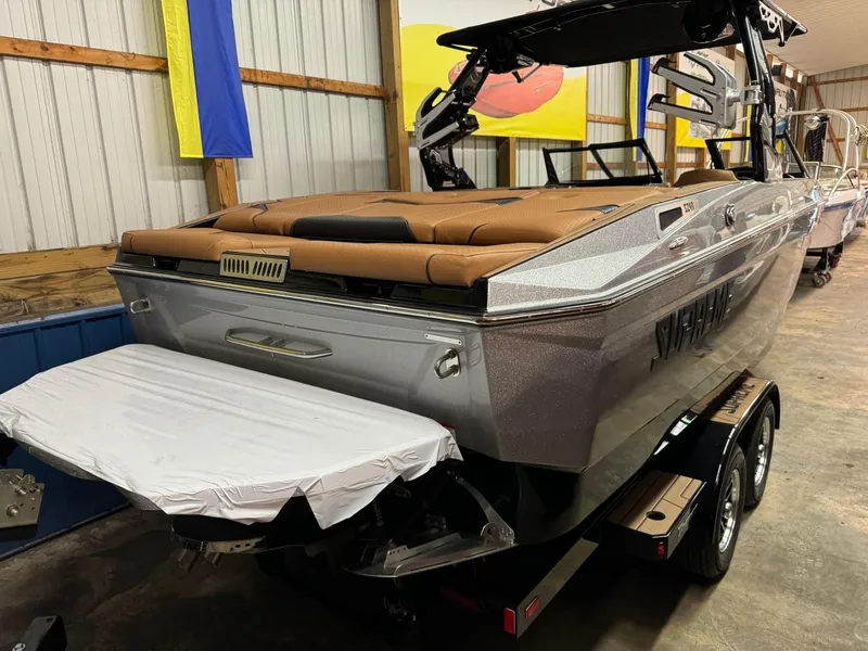 Slide: The Image of 2024 Supreme S240 boat in showroom, featuring sleek design and brown seating. - 21