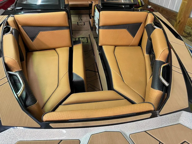 Slide: The Image of 2024 Supreme S240 boat interior with tan and black seating. - 23