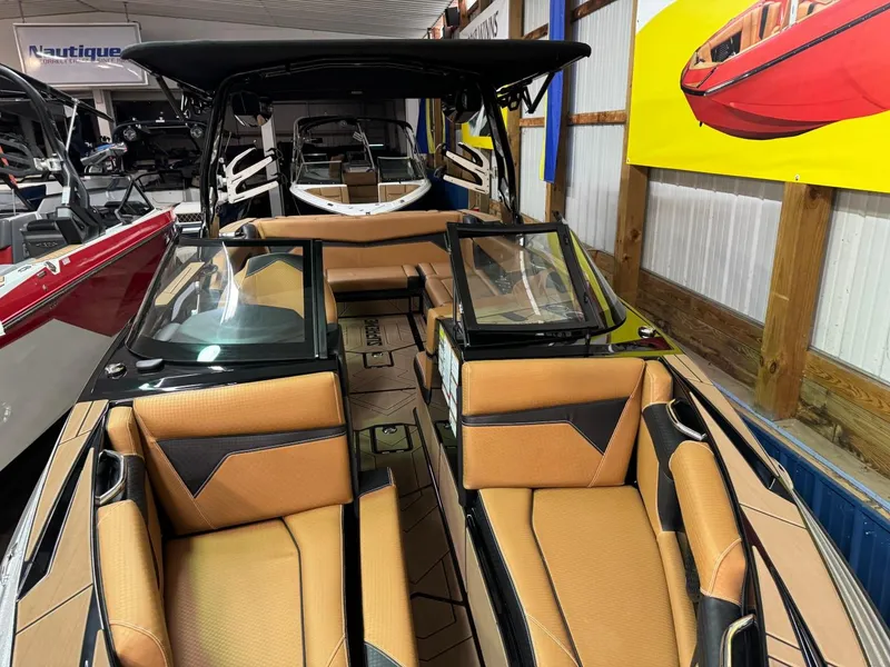 Slide: The Image of 2024 Supreme S240 boat interior with tan leather seats and sleek design. - 24