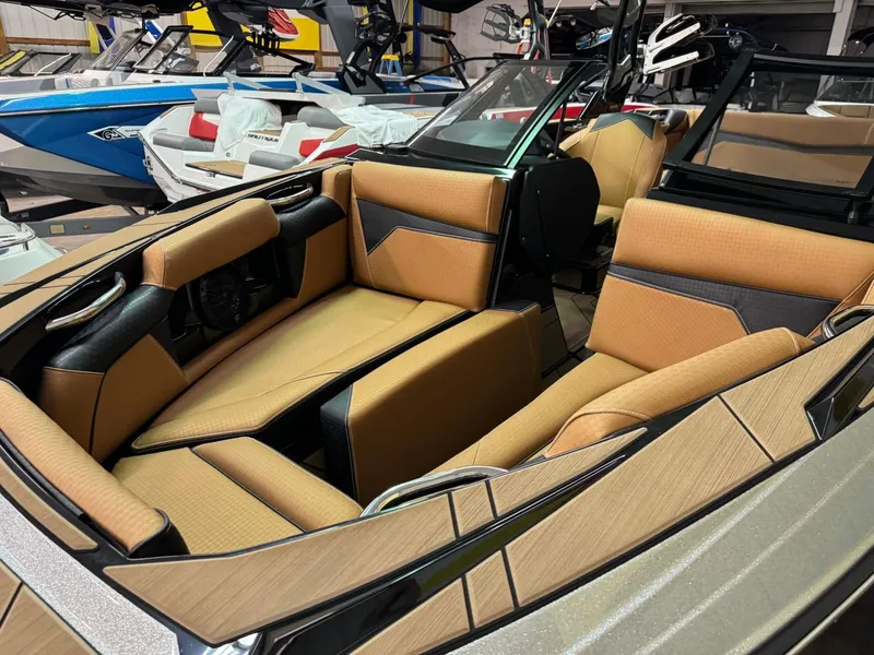 Slide: The Image of 2024 Supreme S240 boat interior with tan and black seating. - 27