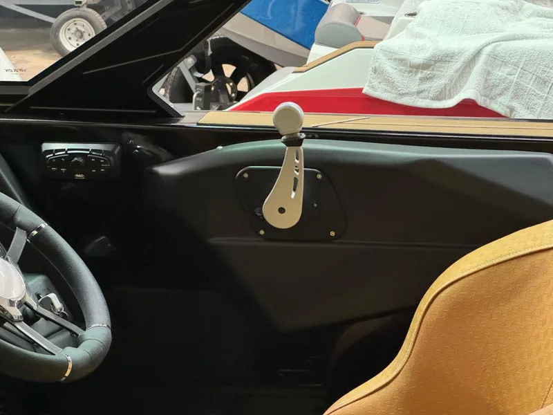 Slide: The Image of 2024 Supreme S240 boat interior with steering wheel and control lever. - 29