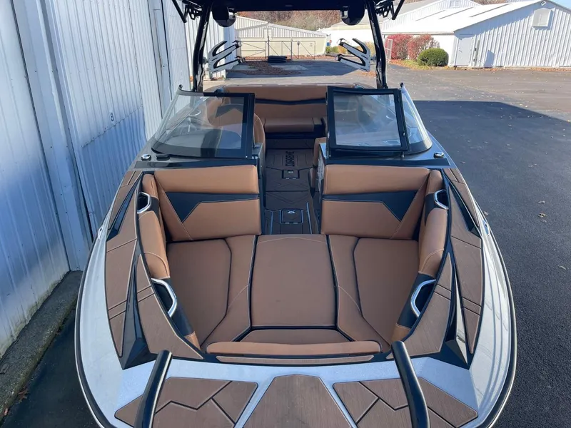 Slide: The Image of 2024 Supreme S240 boat with tan interior and sleek design. - 3