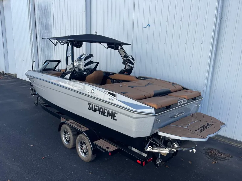Slide: The Image of 2024 Supreme S240 boat on trailer, sleek design, gray and brown color scheme. - 4