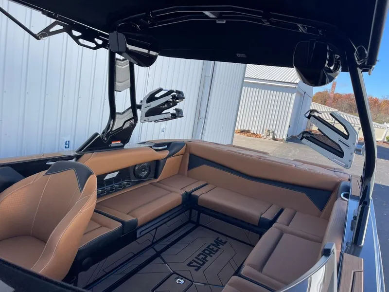 Slide: The Image of 2024 Supreme S240 boat interior with brown seating and modern design. - 7
