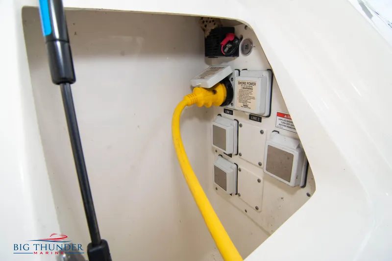 Slide: The Image of Sea Ray 410 Sundancer 2012 power connection with yellow cable in compartment. - 13