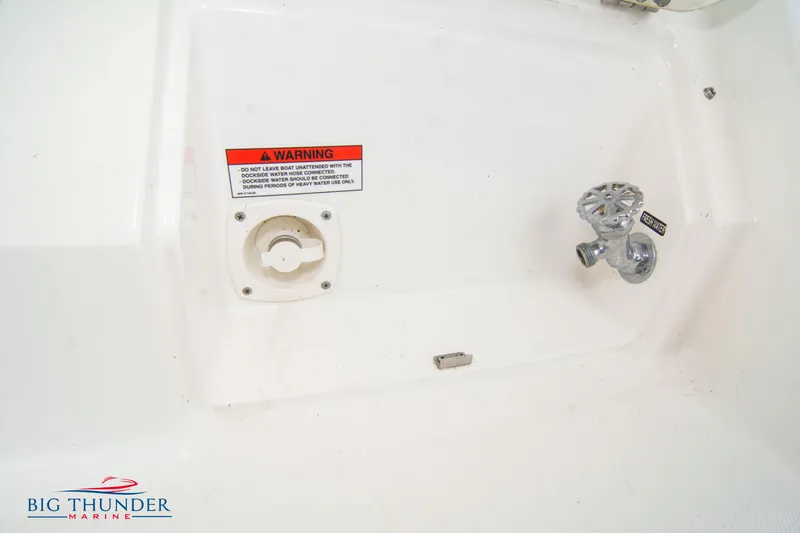 Slide: The Image of Sea Ray 410 Sundancer 2012 boat detail with warning label and valve. - 14