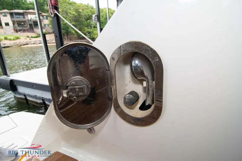 Slide: The Image of 2012 Sea Ray 410 Sundancer fuel cap on deck, open cover. - 15