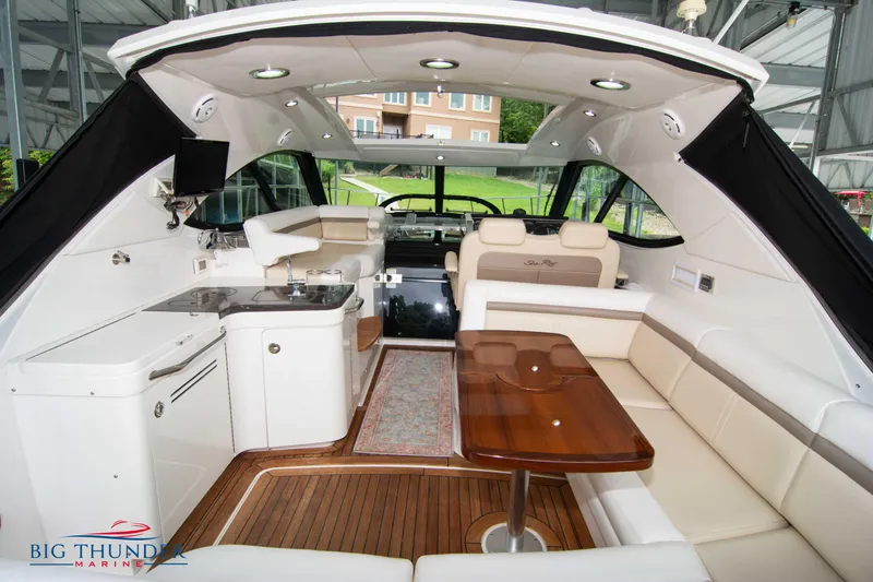 Slide: The Image of Luxurious 2012 Sea Ray 410 Sundancer yacht interior with elegant seating and kitchenette. - 16