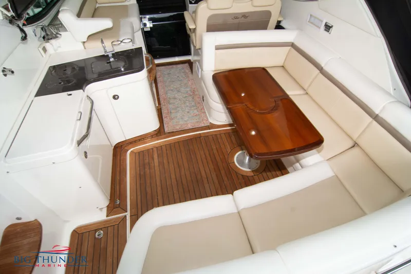 Slide: The Image of Luxurious interior of 2012 Sea Ray 410 Sundancer with wood flooring and plush seating. - 17