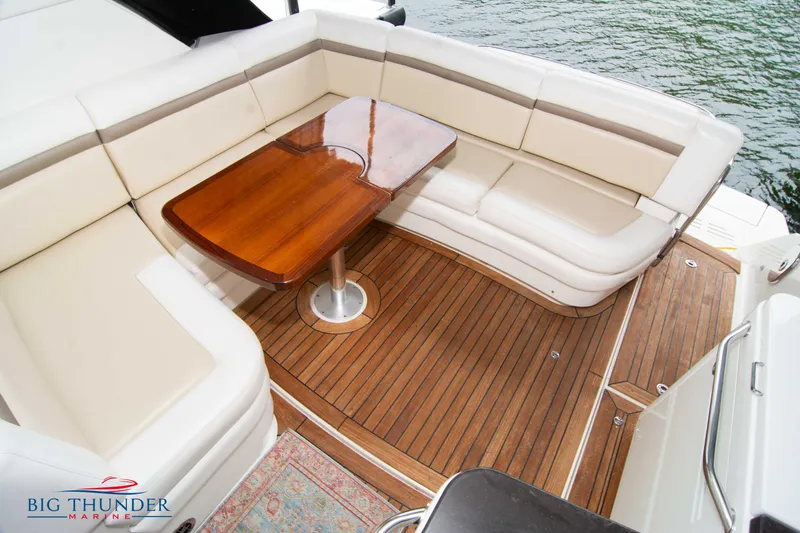 Slide: The Image of Luxurious seating area on 2012 Sea Ray 410 Sundancer yacht with wooden table. - 18