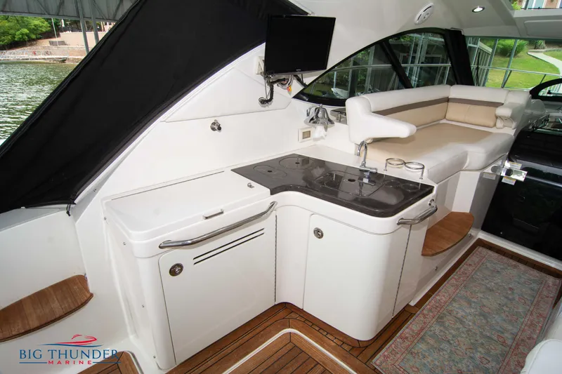 Slide: The Image of Luxurious interior of 2012 Sea Ray 410 Sundancer yacht with kitchenette and seating area. - 20