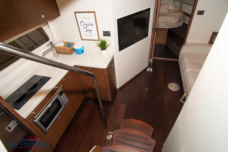 Slide: The Image of Luxurious interior of 2012 Sea Ray 410 Sundancer yacht with modern kitchen and cozy seating. - 43