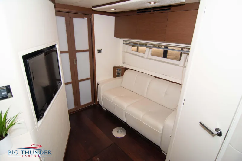 Slide: The Image of Luxurious interior of 2012 Sea Ray 410 Sundancer yacht with white sofa and TV. - 44
