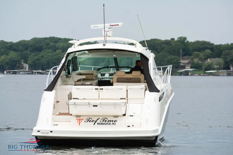Slide: The Image of Sea Ray 410 Sundancer 2012 cruising on a lake with lush green shoreline. - 8