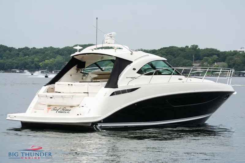 Slide: The Image of 2012 Sea Ray 410 Sundancer yacht on a serene lake. - 9
