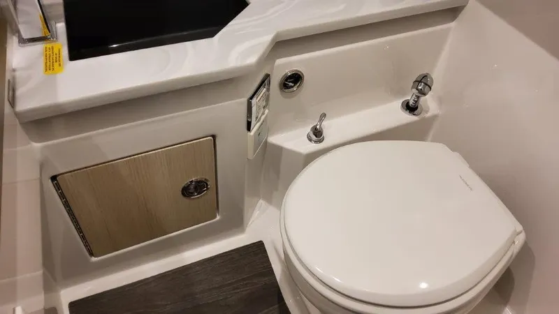 Slide: The Image of 2025 Formula 330 Crossover Bowrider bathroom with modern fixtures and sleek design. - 14