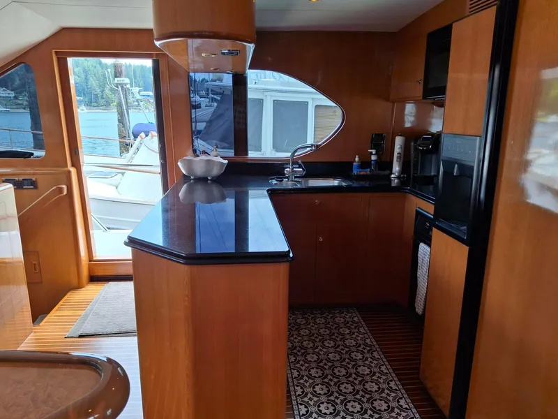 Slide: The Image of Luxurious kitchen interior of 2004 Ocean Alexander 64 Pilothouse yacht with wood cabinetry. - 10