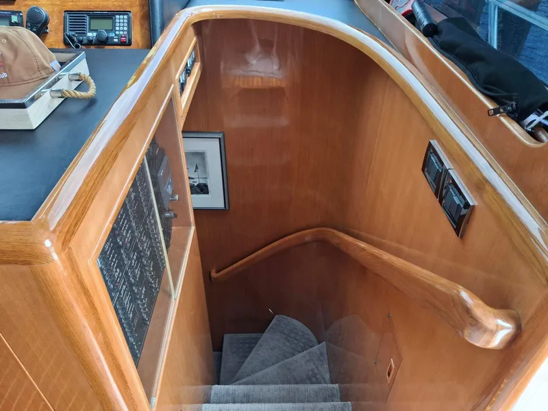 Slide: The Image of Staircase in 2004 Ocean Alexander 64 Pilothouse yacht with wooden handrail and control panel. - 11