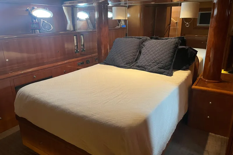 Slide: The Image of Luxurious bedroom interior of 2004 Ocean Alexander 64 Pilothouse yacht with wood finishes. - 12