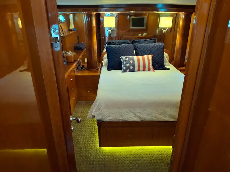 Slide: The Image of Luxurious bedroom in 2004 Ocean Alexander 64 Pilothouse yacht with elegant wood finish. - 13