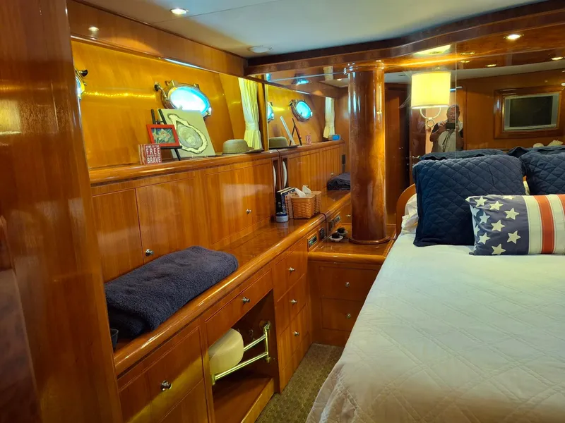 Slide: The Image of Luxurious 2004 Ocean Alexander 64 Pilothouse bedroom with elegant wood finishes and nautical decor. - 14