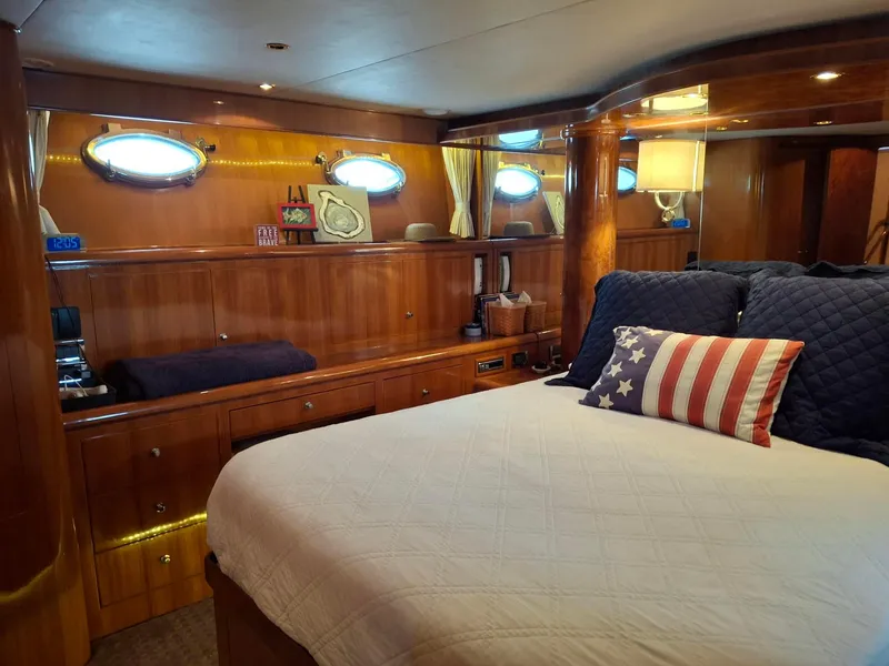 Slide: The Image of Luxurious 2004 Ocean Alexander 64 Pilothouse bedroom with elegant wood finish and nautical decor. - 15