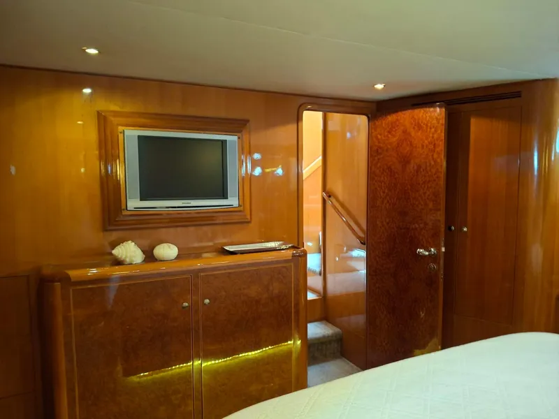 Slide: The Image of Luxurious interior of 2004 Ocean Alexander 64 Pilothouse yacht with wood paneling and TV. - 18