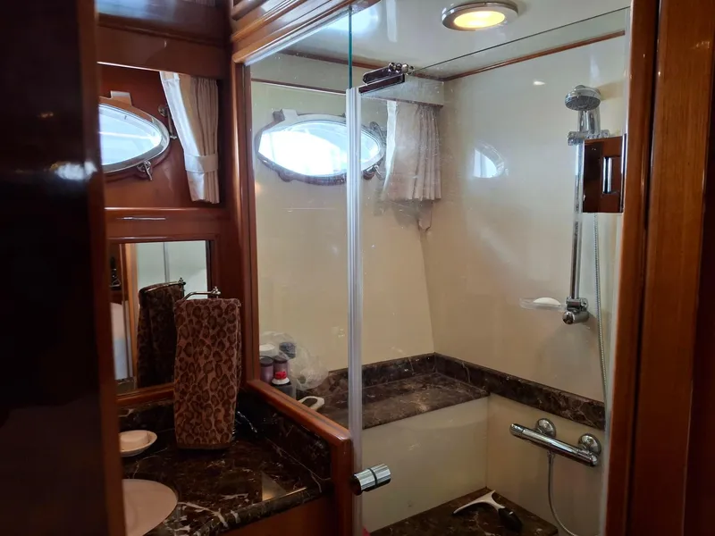 Slide: The Image of Luxurious bathroom in 2004 Ocean Alexander 64 Pilothouse yacht with marble accents and shower. - 20