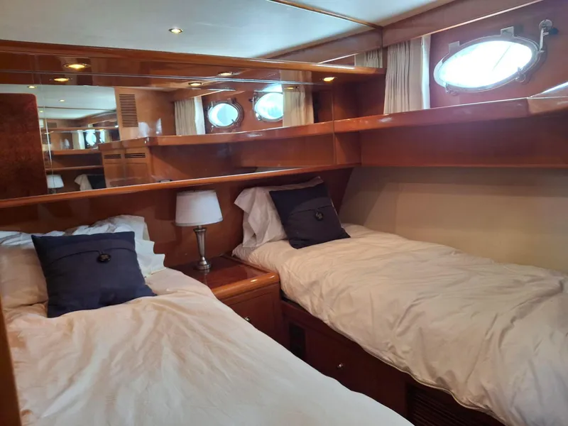 Slide: The Image of Luxurious twin cabin in 2004 Ocean Alexander 64 Pilothouse yacht with elegant wood finish. - 22