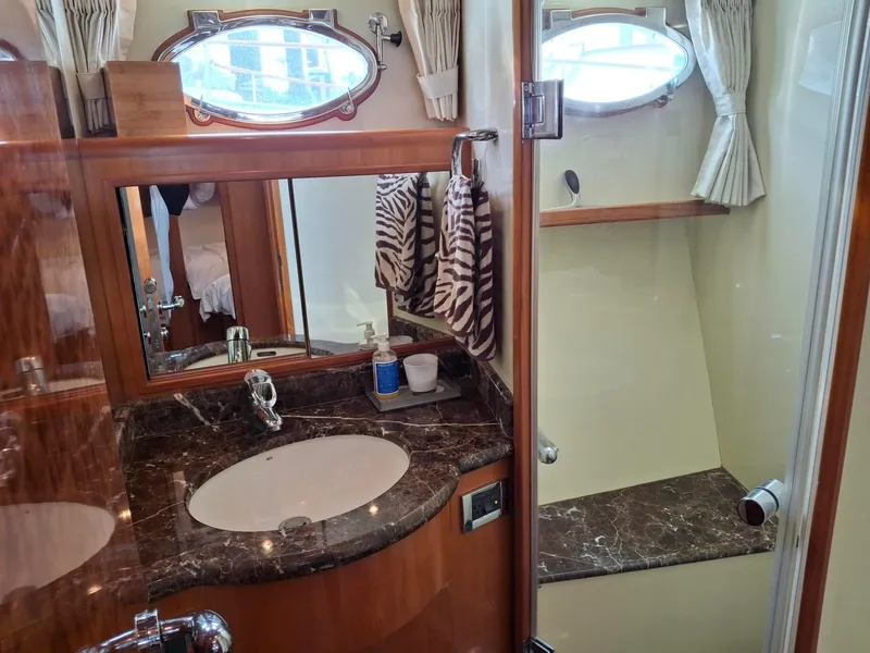 Slide: The Image of Luxurious bathroom in 2004 Ocean Alexander 64 Pilothouse yacht with marble countertop and shower. - 23
