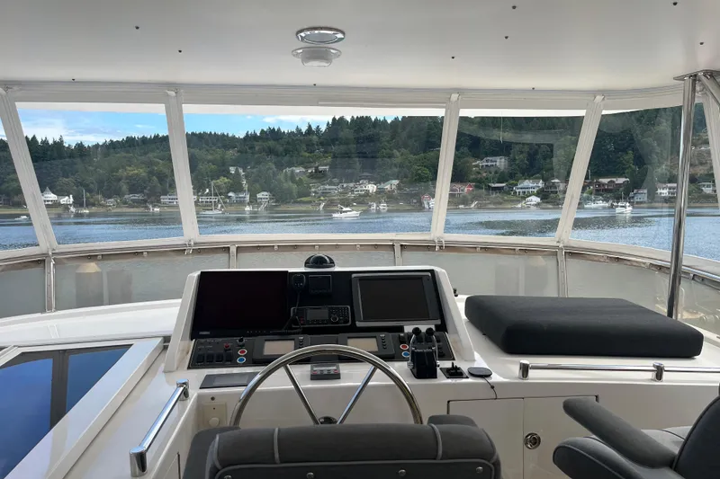 Slide: The Image of Pilothouse interior of 2004 Ocean Alexander 64, overlooking scenic waterfront homes. - 25