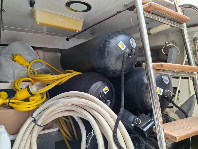 Slide: The Image of Storage area on a 2004 Ocean Alexander 64 Pilothouse with cables and fenders. - 39