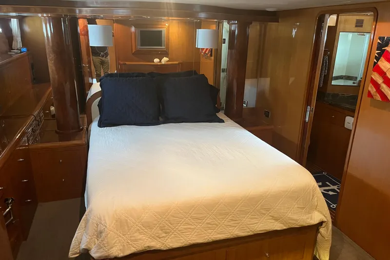 Slide: The Image of Luxurious bedroom interior of 2004 Ocean Alexander 64 Pilothouse yacht with elegant wood finishes. - 4