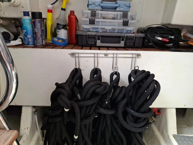 Slide: The Image of Storage area on a 2004 Ocean Alexander 64 Pilothouse with ropes and maintenance supplies. - 44