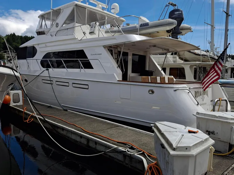 Slide: The Image of 2004 Ocean Alexander 64 Pilothouse yacht docked at marina with American flag. - 47