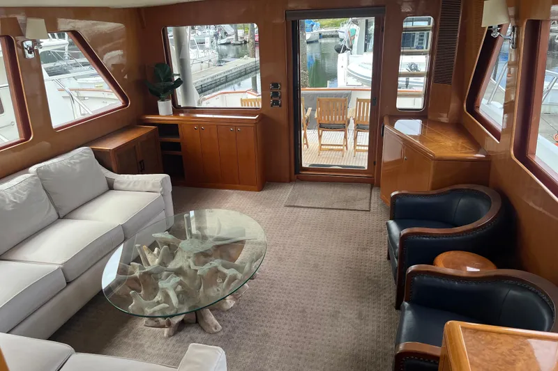 Slide: The Image of Luxurious interior of 2004 Ocean Alexander 64 Pilothouse yacht with elegant seating and glass table. - 5