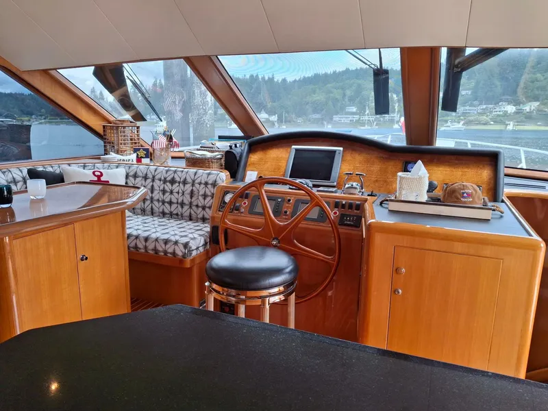Slide: The Image of Pilothouse interior of 2004 Ocean Alexander 64, featuring wood finishes and navigation equipment. - 8