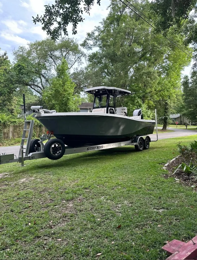 The Image of 2024 Blue Wave 2600 Makaira boat on trailer, parked on grassy area. - 0